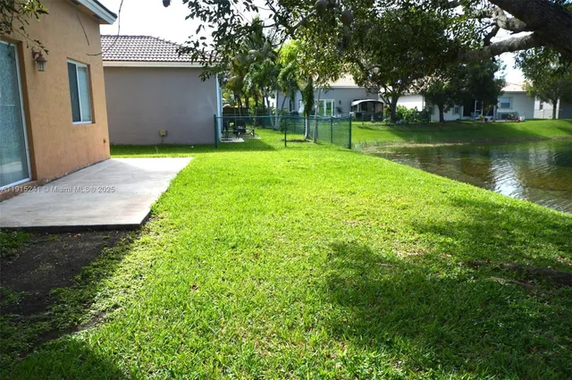a view of a backyard with large trees