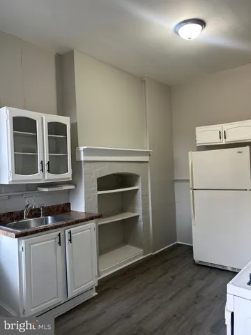 a kitchen with granite countertop a stove and a refrigerator
