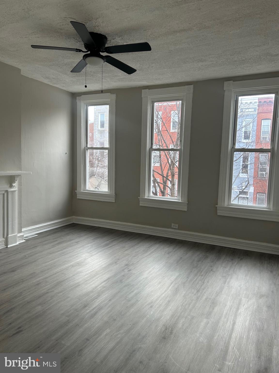 1619 1/2 Division Street Baltimore, MD 21217 - Photo 13 of 22 a view of an empty room with wooden floor and a window