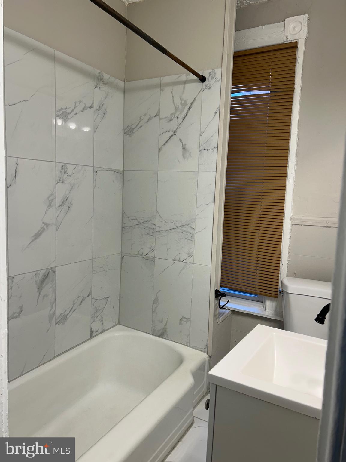 1619 1/2 Division Street Baltimore, MD 21217 - Photo 20 of 22 a bathroom with a bathtub and a shower