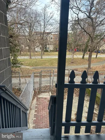 a view of a porch with wooden floor and fence