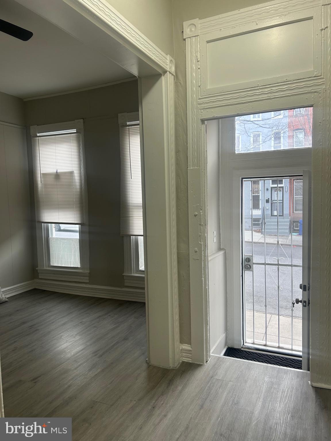 1619 1/2 Division Street Baltimore, MD 21217 - Photo 4 of 22 an empty room with wooden floor and windows