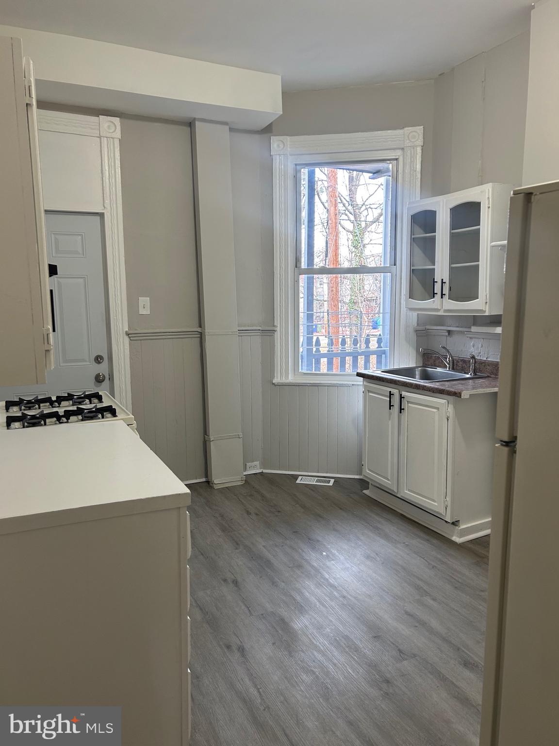 1619 1/2 Division Street Baltimore, MD 21217 - Photo 7 of 22 a view of a kitchen with a sink dishwasher and wooden floor