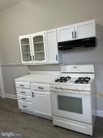 a kitchen with stainless steel appliances granite countertop a stove and a microwave