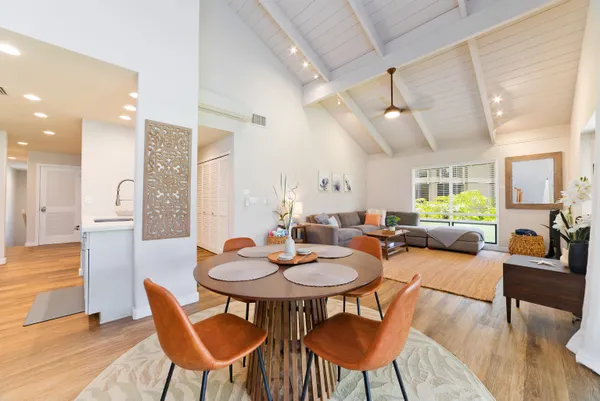 a dining room with furniture and wooden floor