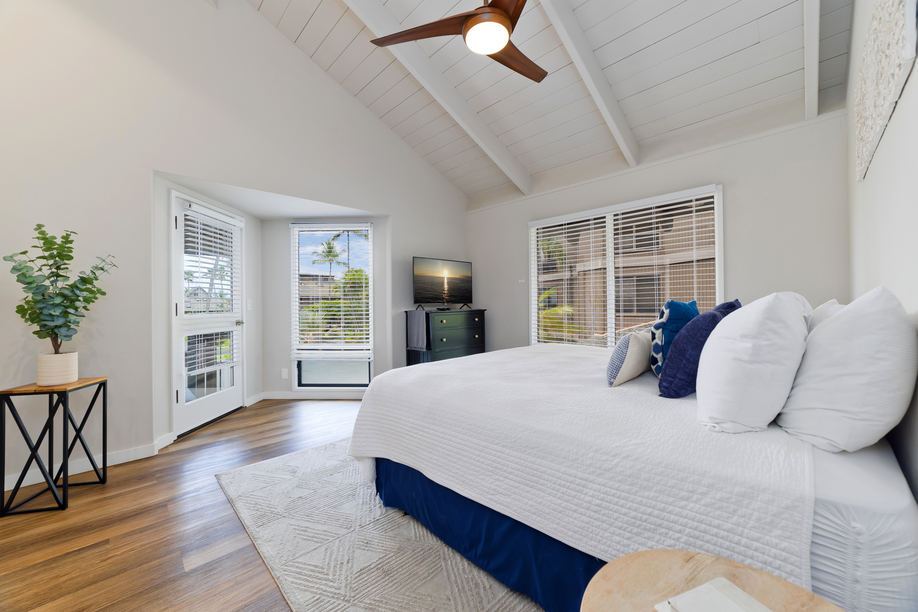 78-261 Manukai Street, Unit 303 Kailua-Kona, HI 96740 - Photo 12 of 30 a bedroom with a large bed and a potted plant