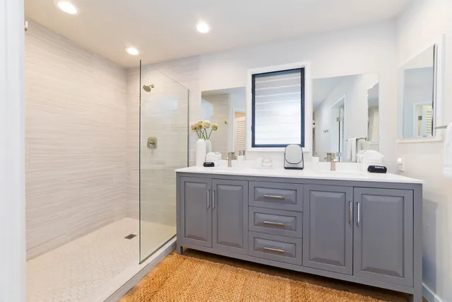 a bathroom with a tub a sink and mirrors