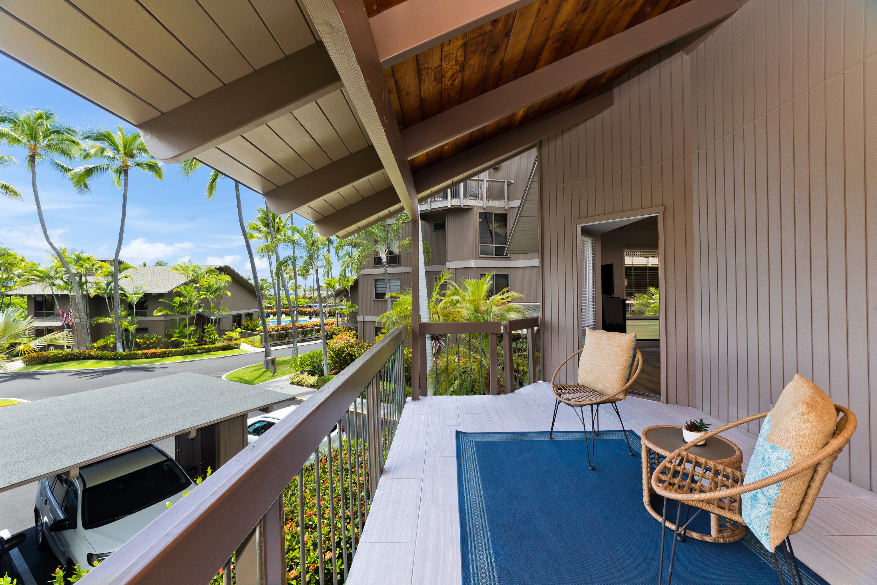 78-261 Manukai Street, Unit 303 Kailua-Kona, HI 96740 - Photo 16 of 30 a view of a chairs and table in patio with a swimming pool