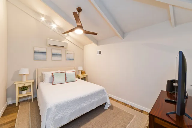 a bedroom with a bed and a desk