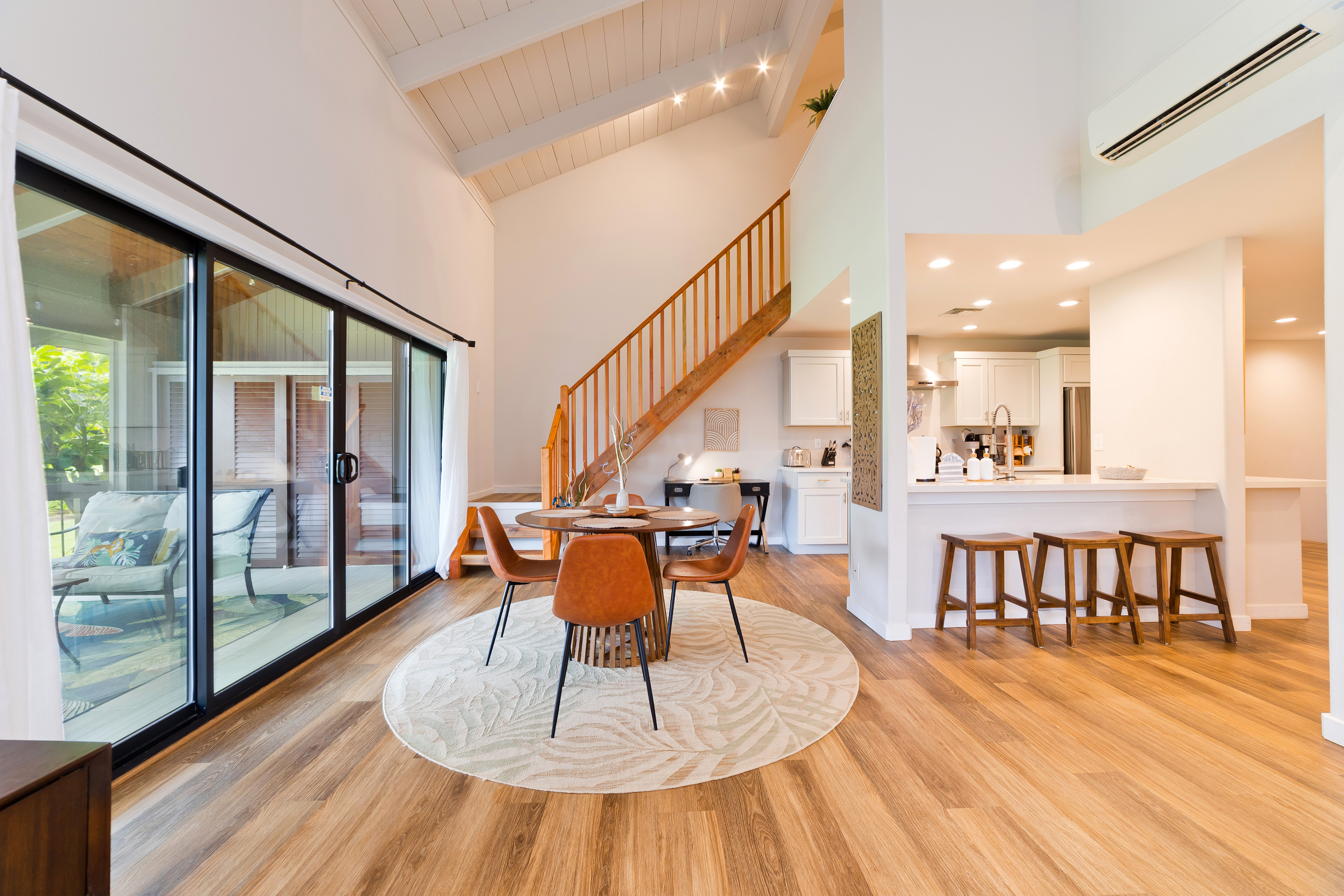 78-261 Manukai Street, Unit 303 Kailua-Kona, HI 96740 - Photo 2 of 30 a dining room with wooden floor and large windows