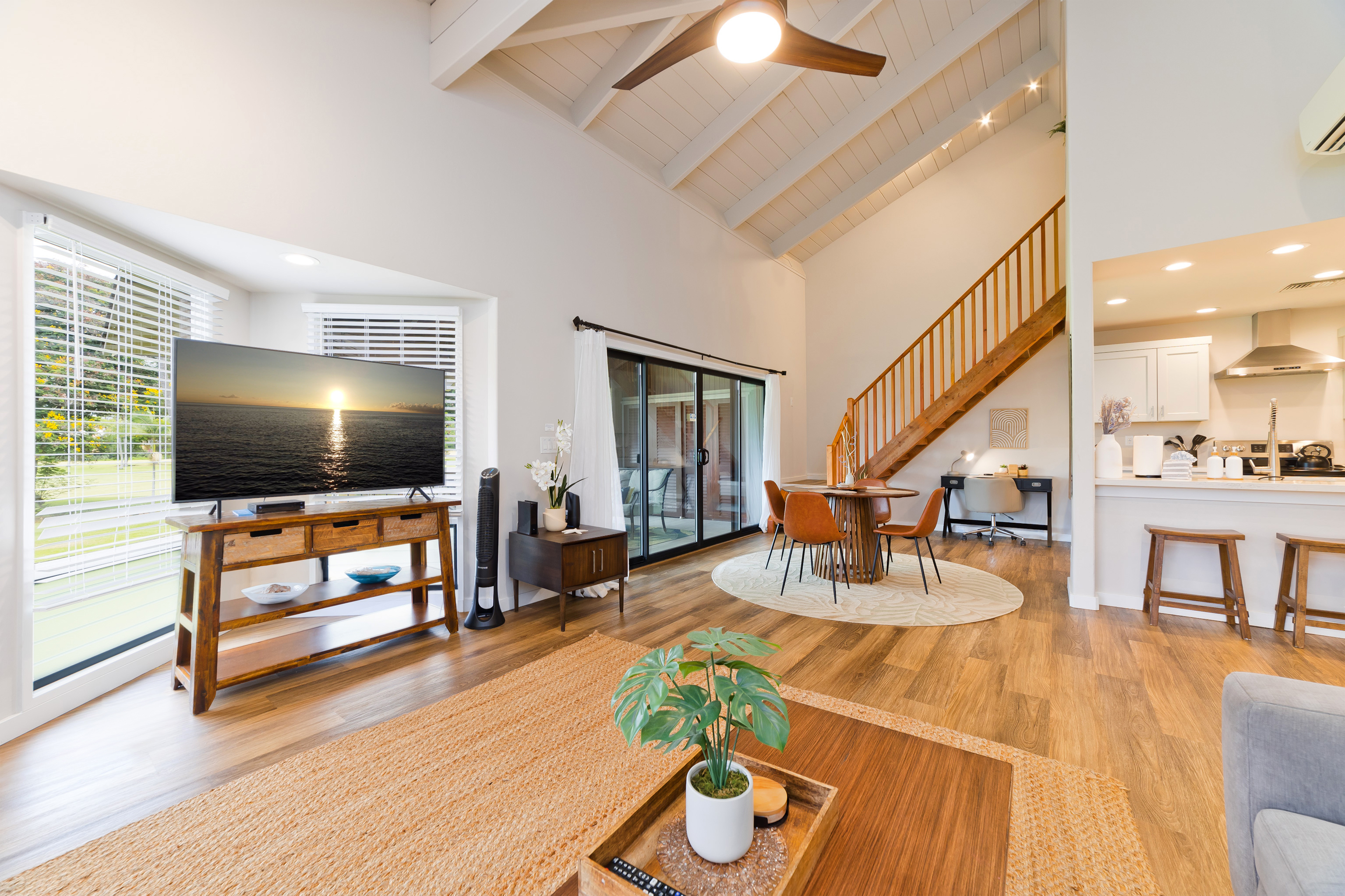78-261 Manukai Street, Unit 303 Kailua-Kona, HI 96740 - Photo 4 of 30 a living room with furniture and a flat screen tv
