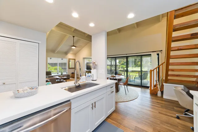 a large white kitchen with a large window