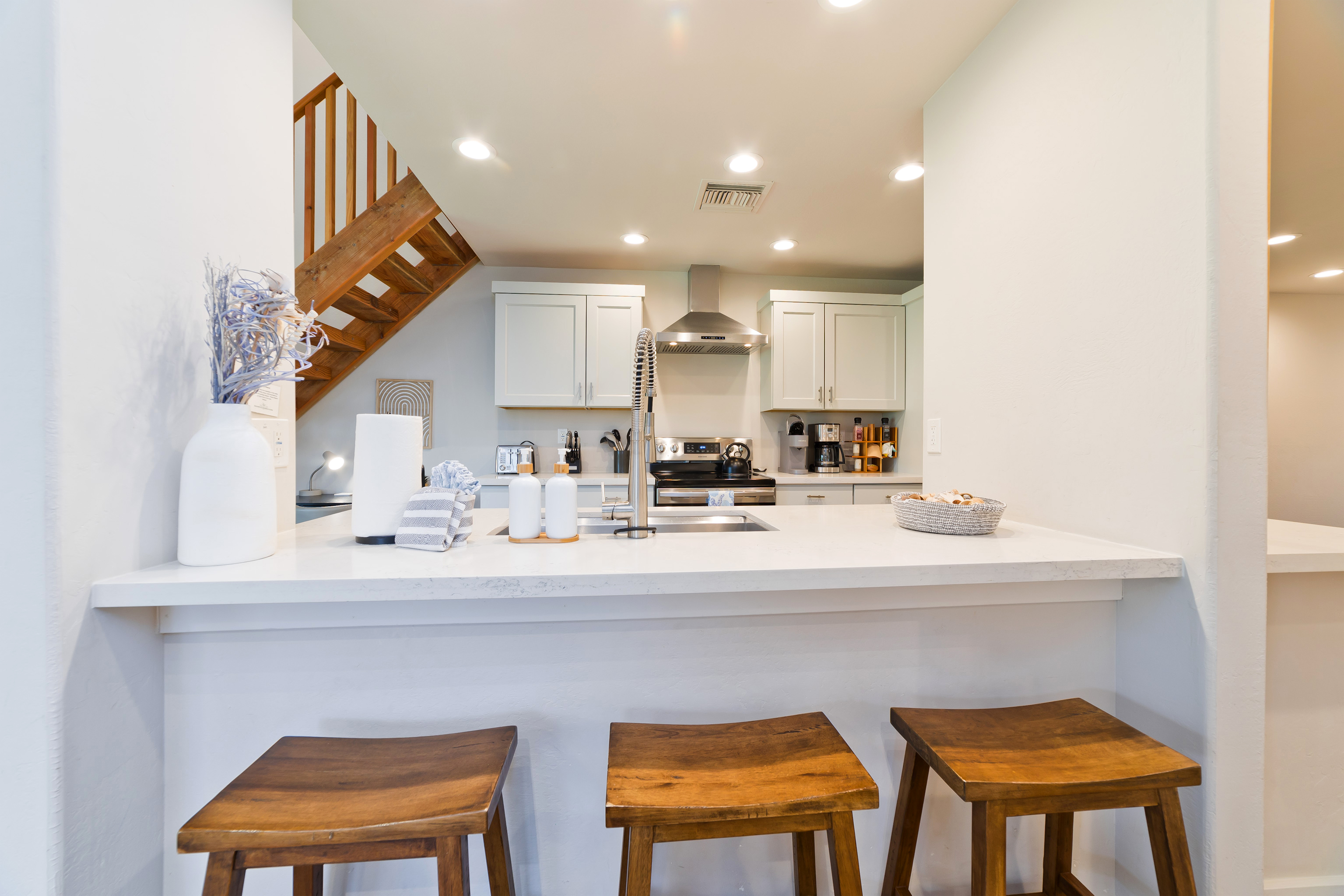 78-261 Manukai Street, Unit 303 Kailua-Kona, HI 96740 - Photo 9 of 30 a kitchen with a sink cabinets and window