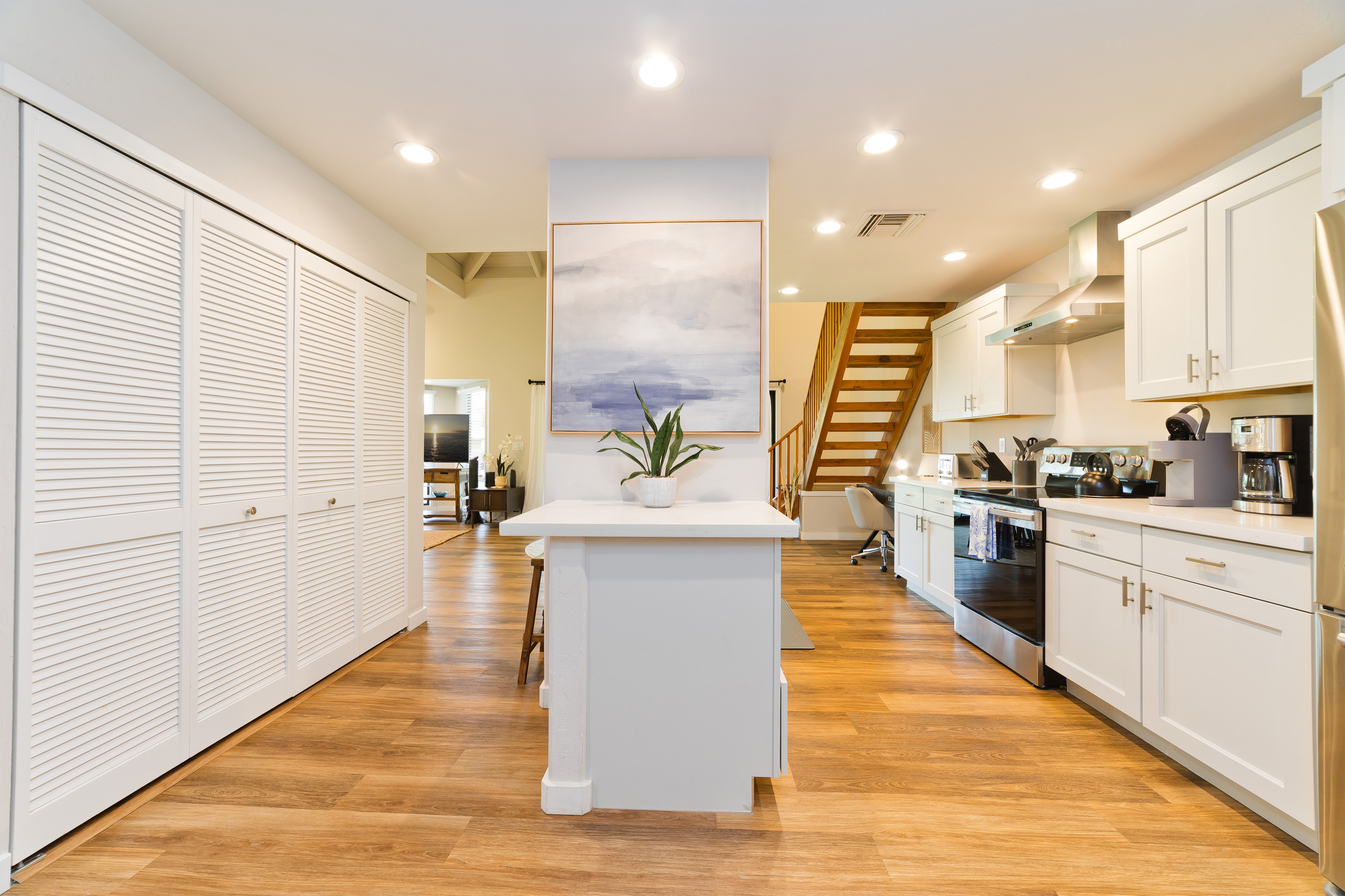 78-261 Manukai Street, Unit 303 Kailua-Kona, HI 96740 - Photo 10 of 30 a large kitchen with stainless steel appliances a large counter top a stove a sink and a refrigerator