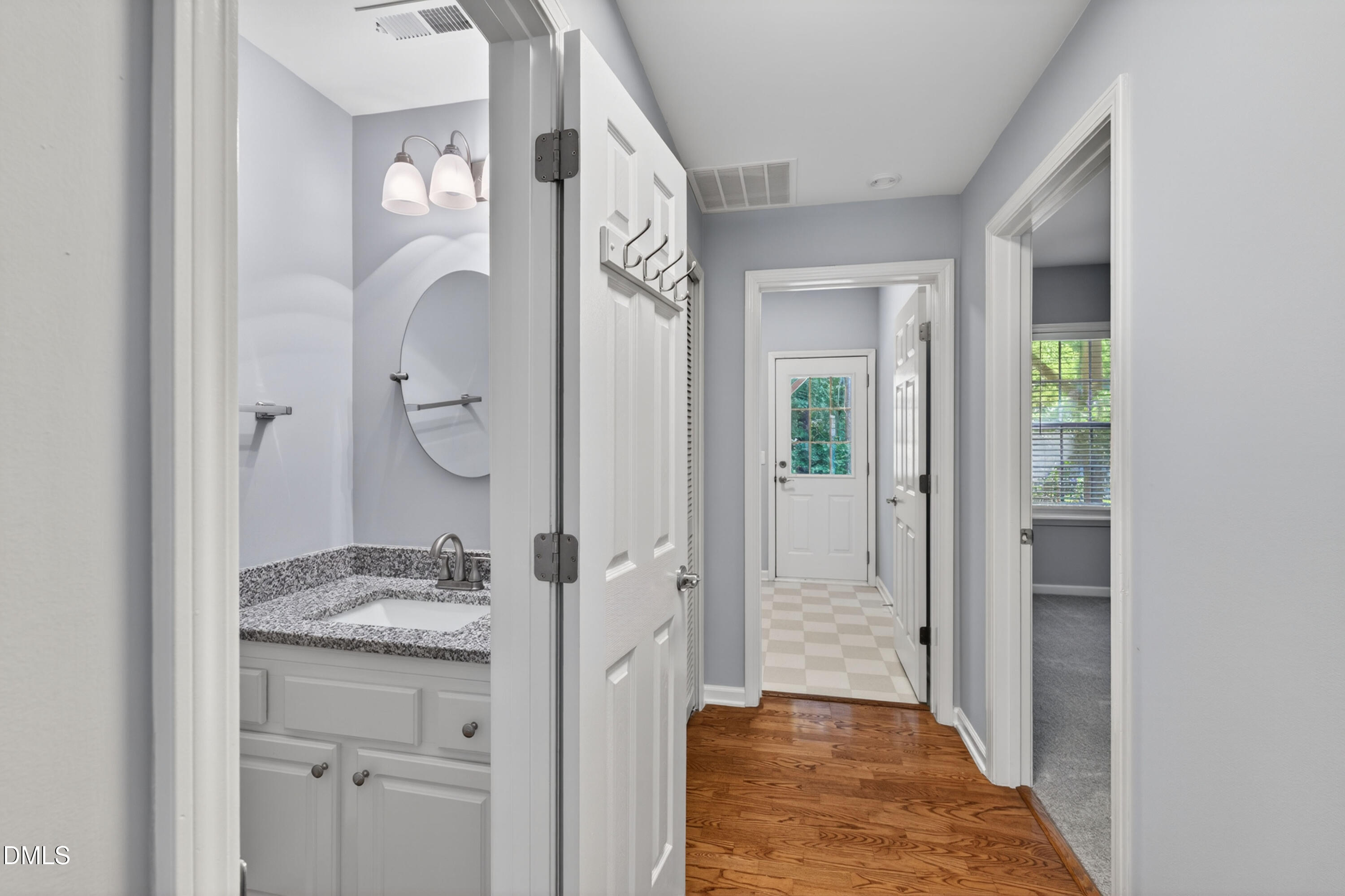 5421 Golden Arrow Lane Raleigh, NC 27613 - Photo 8 of 49 a bathroom with a granite countertop sink a mirror and a shower