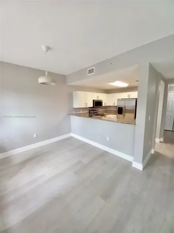 a view of a kitchen with a sink and a stove top oven