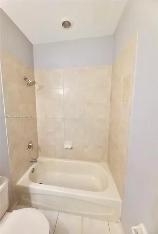 a bathroom with a bathtub and toilet