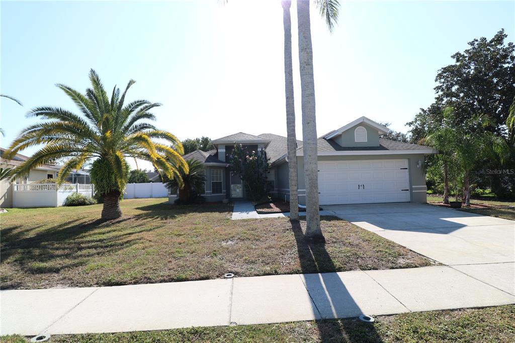 a front view of house with yard and car parked