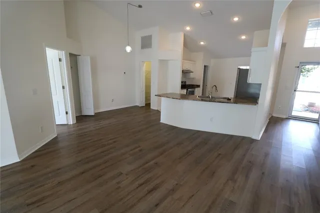 a view of kitchen with wooden floor and electronic appliances