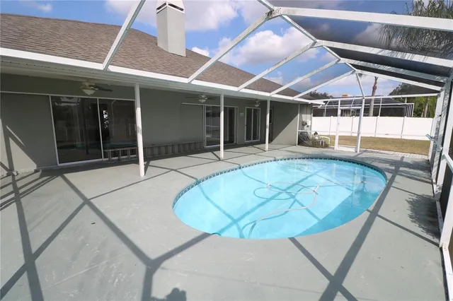 a view of a house with backyard porch and sitting area