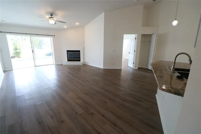a view of a room with wooden floor and windows