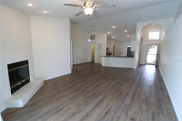 a view of a house with a fireplace and wooden floor