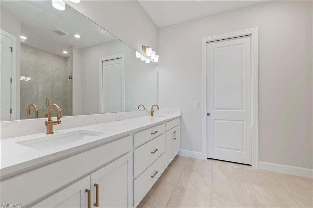 15328 Lucerna Street, Unit 202 Naples, FL 34114 - Photo 17 of 32 a bathroom with double vanity sink and a mirror