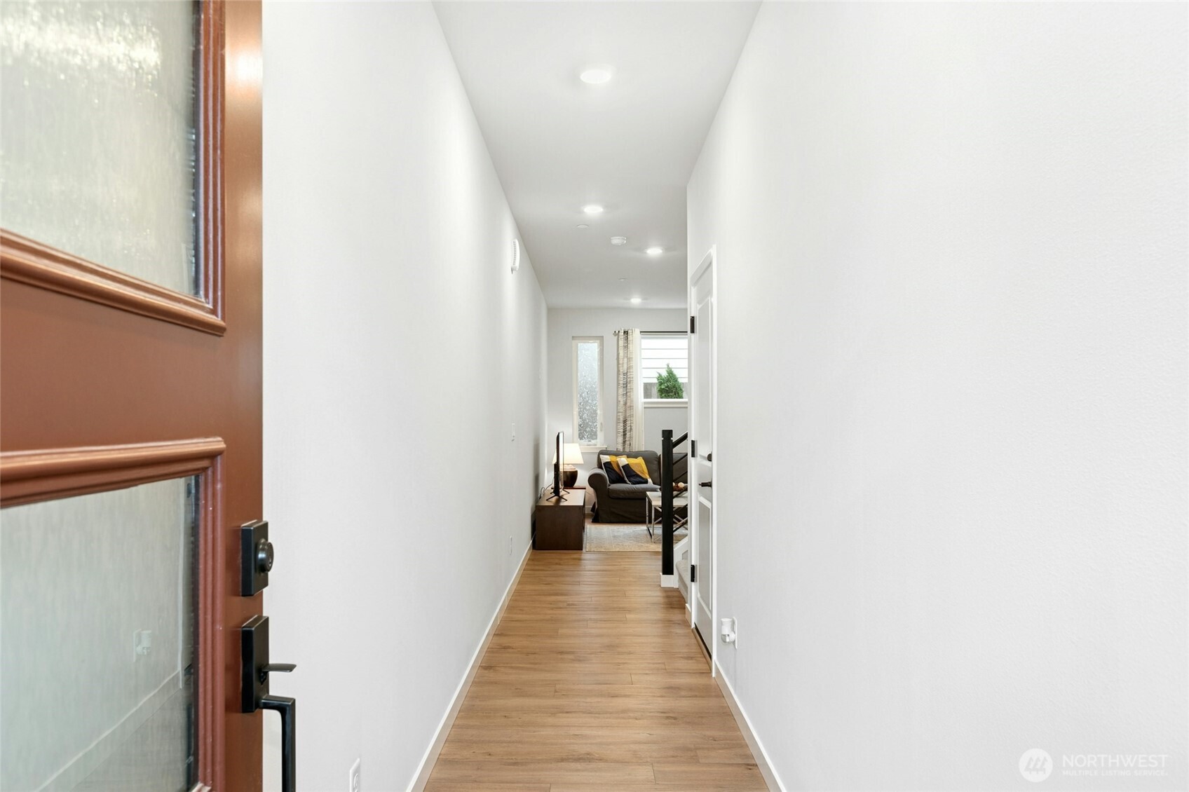 8609 Soper Hill Road, Unit G147 Marysville, WA 98270 - Photo 4 of 28 a view of a hallway with wooden floor and furniture