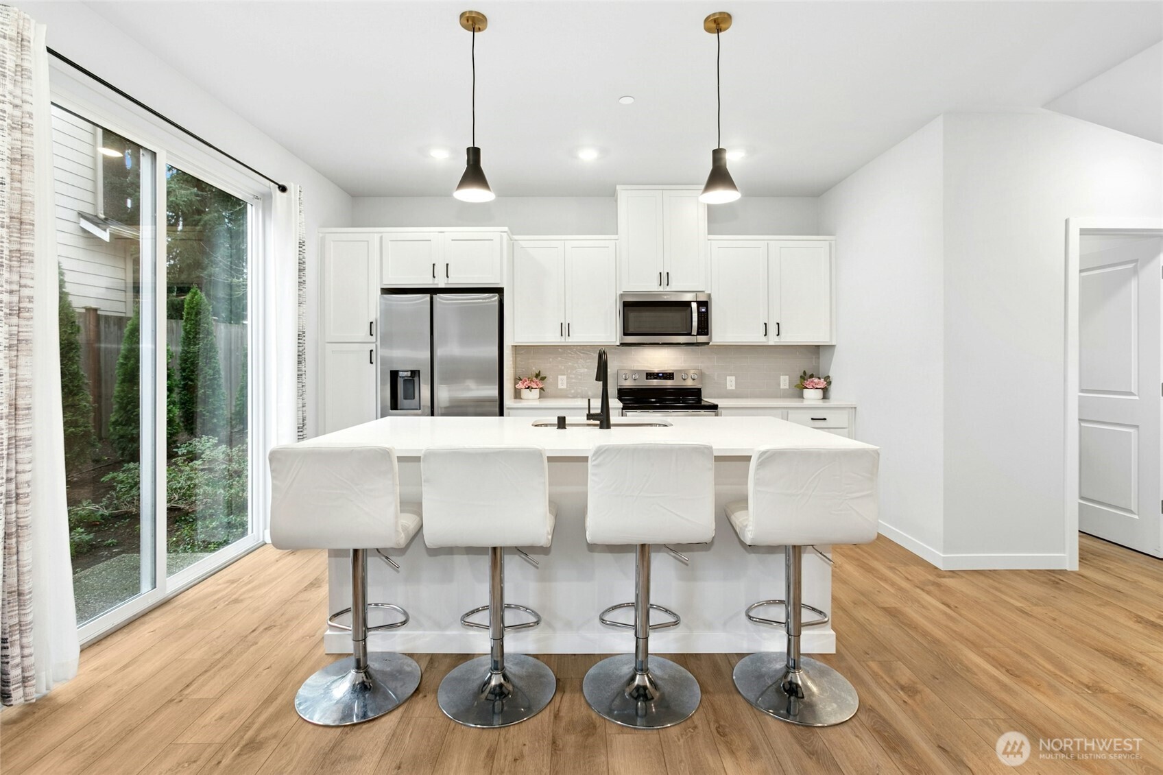 8609 Soper Hill Road, Unit G147 Marysville, WA 98270 - Photo 8 of 28 a kitchen with kitchen island granite countertop a table chairs refrigerator and microwave