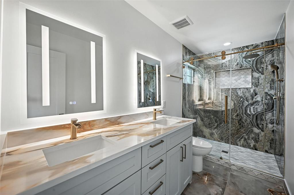 934 Elwood Road Irving, TX 75061 - Photo 14 of 40 a bathroom with a shower sink and mirror