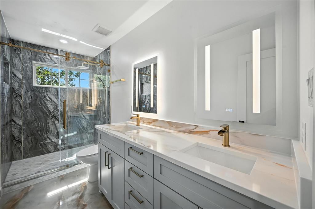 934 Elwood Road Irving, TX 75061 - Photo 17 of 40 a bathroom with a sink and a mirror