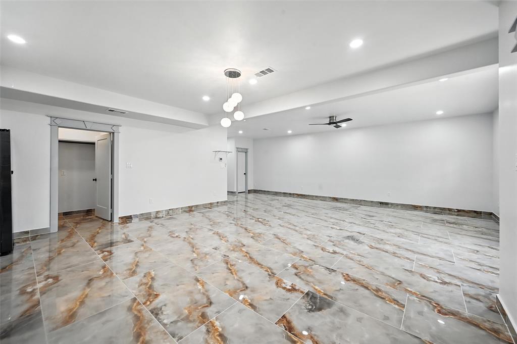 934 Elwood Road Irving, TX 75061 - Photo 23 of 40 an empty room with kitchen view and natural light