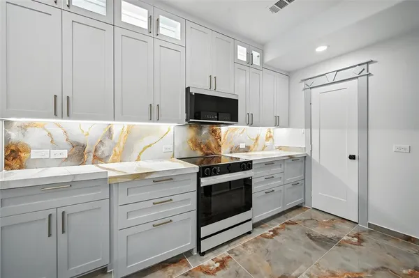 a kitchen with a stove and a sink