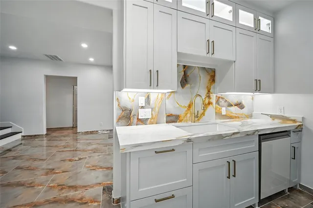a kitchen with stainless steel appliances granite countertop a sink and cabinets