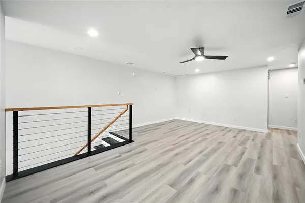 a view of an empty room and wooden floor