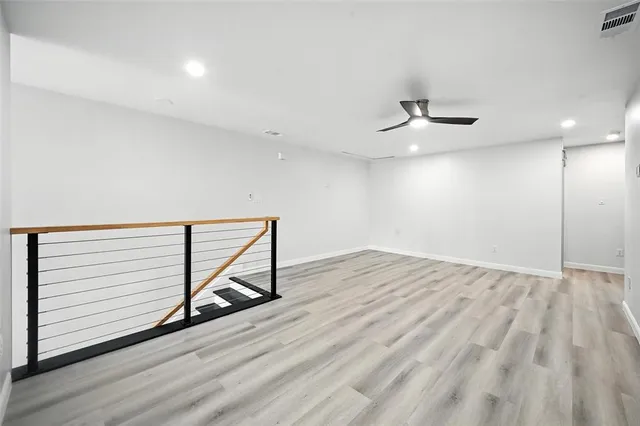 a view of an empty room and wooden floor