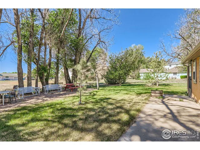 a view of a house with backyard sitting area and garden