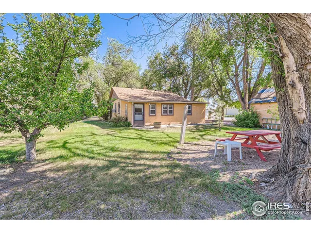 an aerial view of a house with a yard and lake view