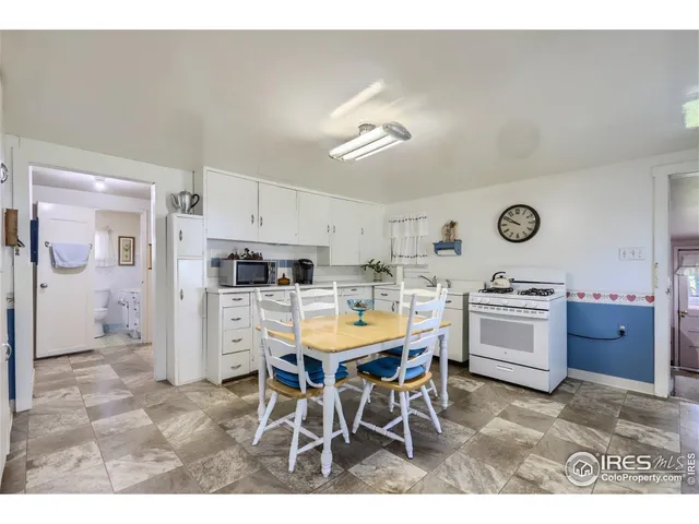 a kitchen with a table and chairs in it