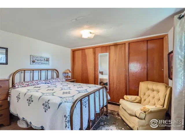 a bedroom with a bed a couch and dresser