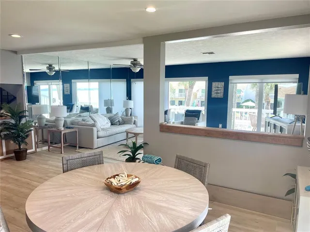 a dining table with chairs and wooden floor