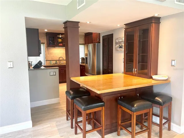 a kitchen with stainless steel appliances granite countertop a refrigerator and a sink