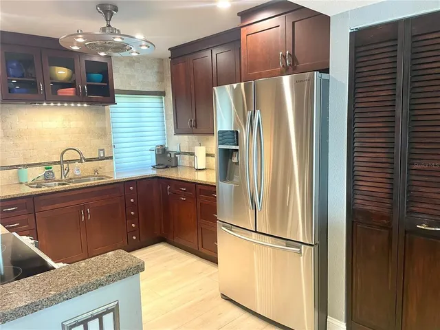 a kitchen with stainless steel appliances granite countertop a sink a stove and oven