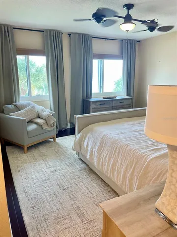 a bedroom with a bed and a night stand