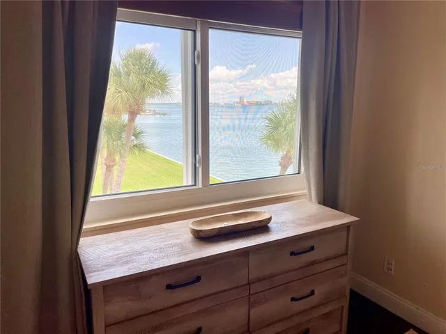 a bathroom with a granite countertop sink a large mirror and a toilet