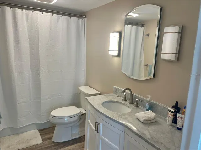 a bedroom with a bed and flat screen tv