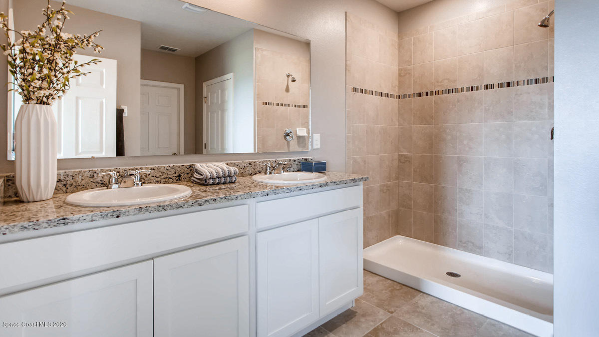 466 Old Country Rd S East Palm Bay, FL 32909 - Photo 8 of 26 a bathroom with a sink a toilet and shower