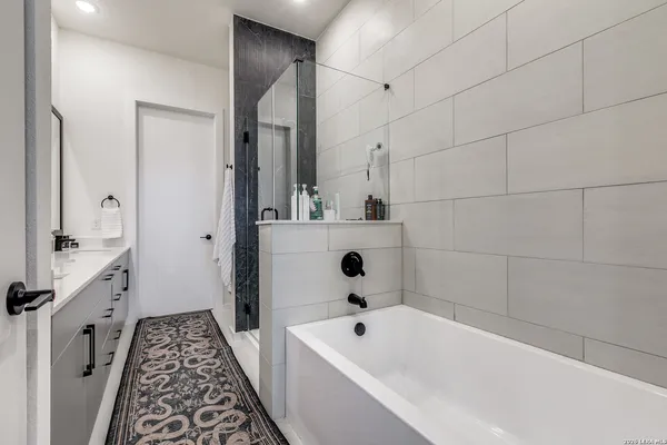 a bathroom with a bathtub and a shower