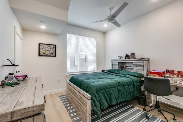 a living room with a bed furniture and a window