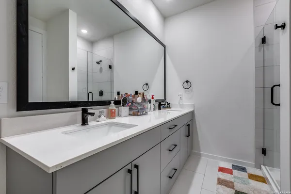 a bathroom with a sink double vanity and a mirror